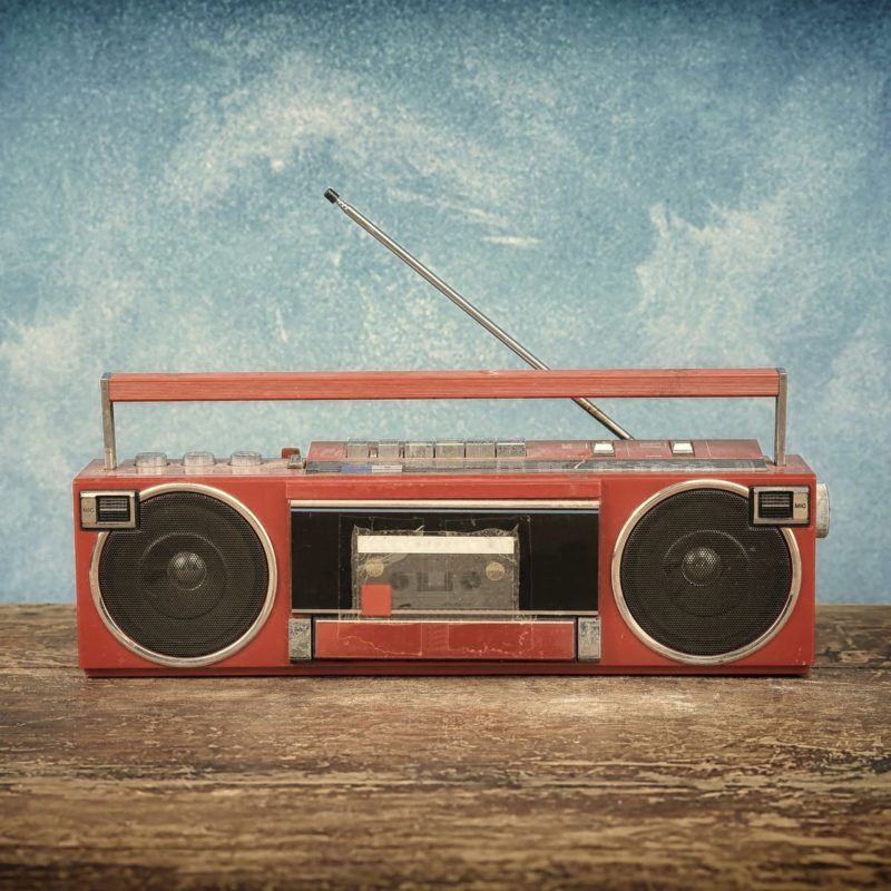 Old retro radio on table blue background