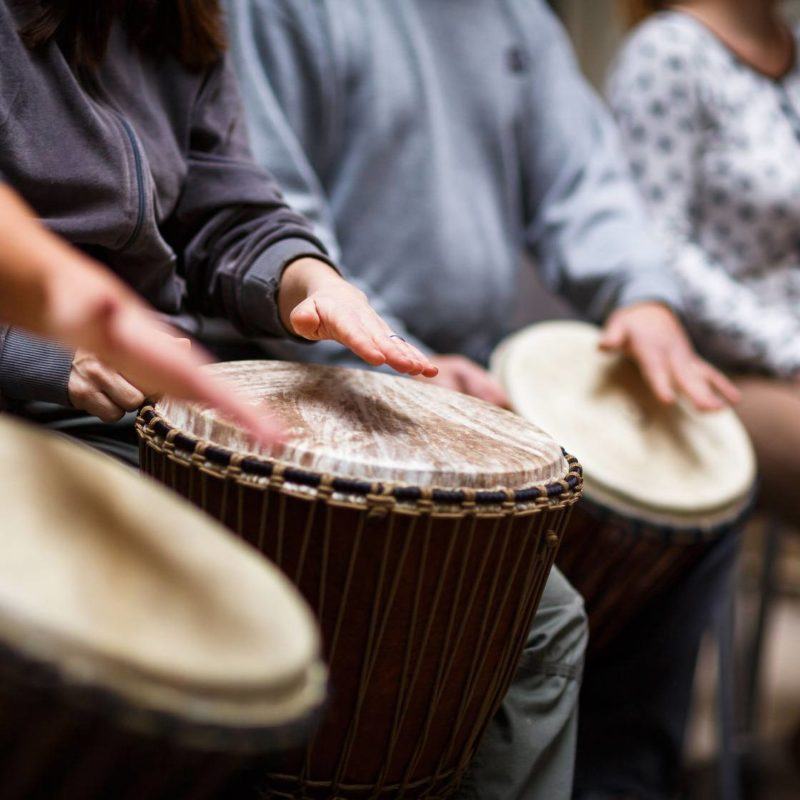 group of people playing percussion: therapy by sound