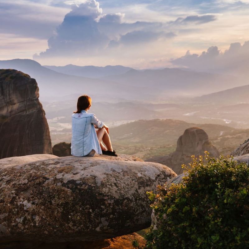 40501462 - beautiful tourist in greece with the meteora monasteries in the background