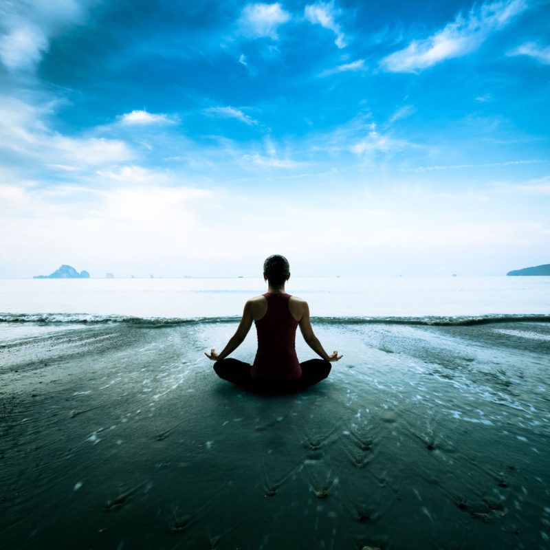 40973272 - silhouette young woman practicing yoga on the beach