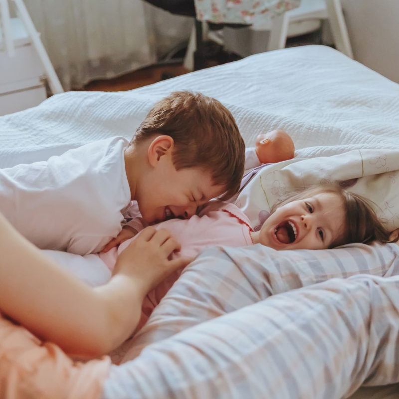 43348032 - closeup of happy family playing over the bed in a relaxed morning. weekend family leisure time concept.