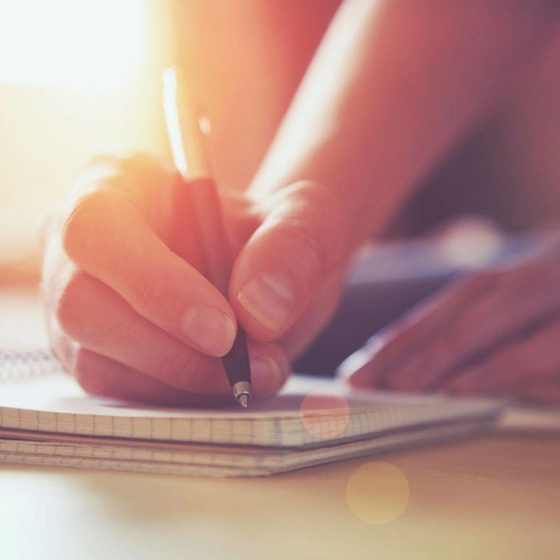 46651061 - female hands with pen writing on notebook