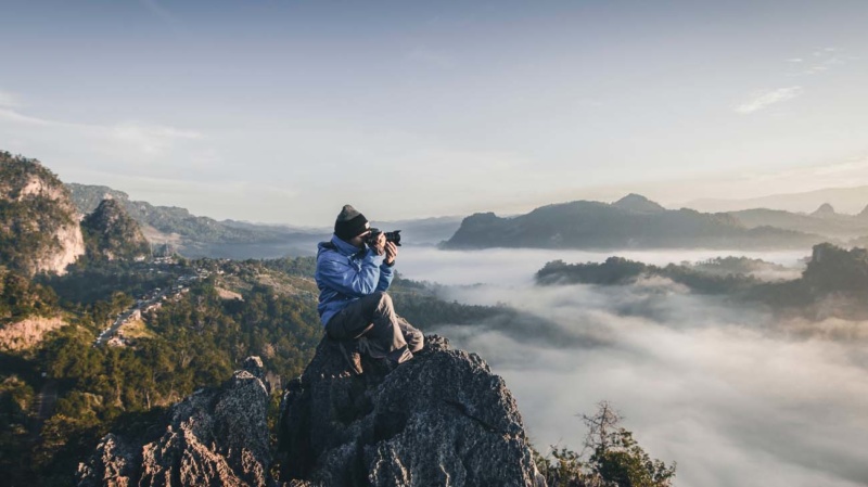 photographer practicing on top of a mountain