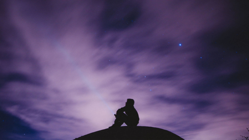 man on a mountain using quantum mind power to attract good things into his life