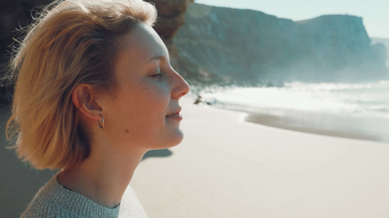 woman thinking positive thoughts and emitting positive energy