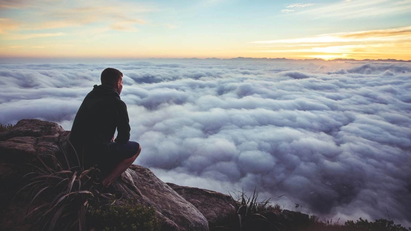 Man connecting to the energy of faith on a mountain top