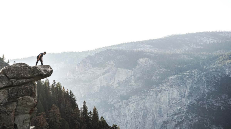 Man over cliff dealing with self-limiting beliefs