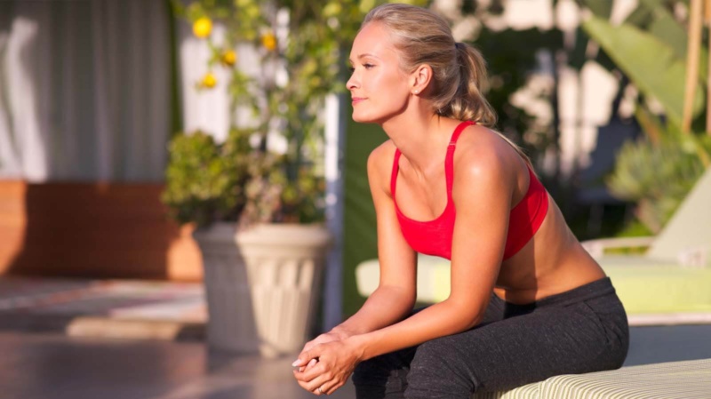 Woman in athletic clothes visualizing positive thoughts