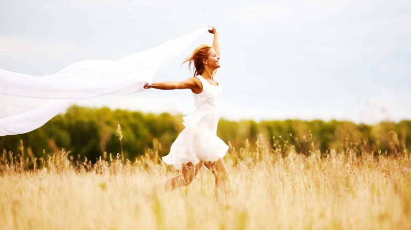 Woman running in a field of flowers