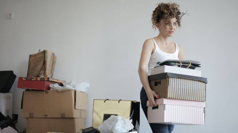 Girl getting rid of clutter in her apartment