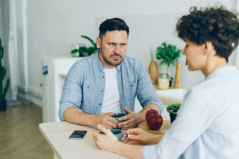 Angry man is having a hard time forgiving woman across table