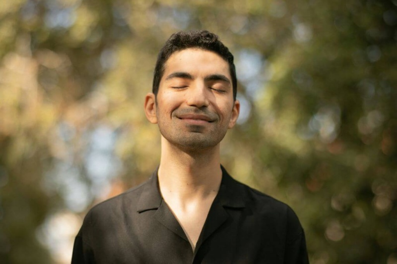 Man with eyes closed manifesting someone