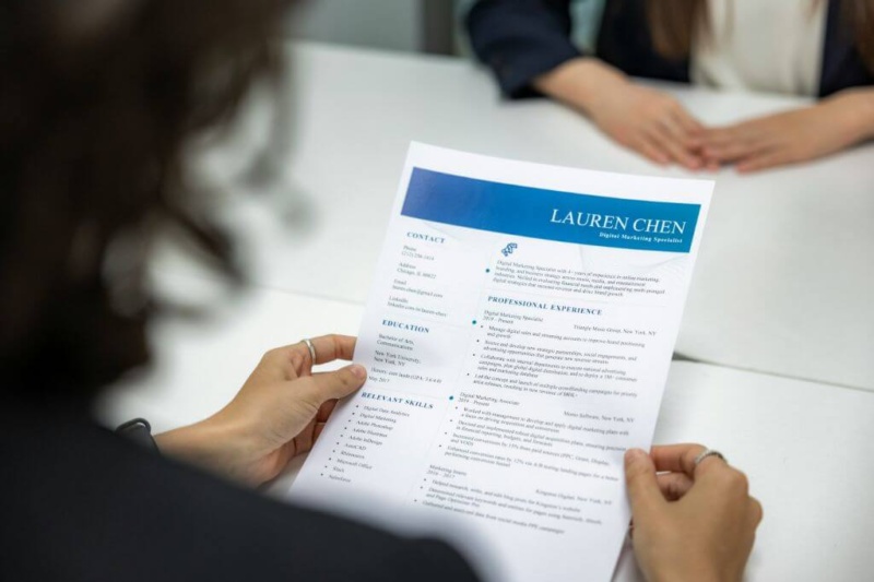 Recruiter reviewing a resume in front of a candidate